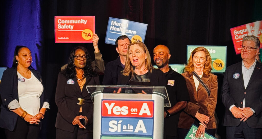 Elise speaking in front of podium